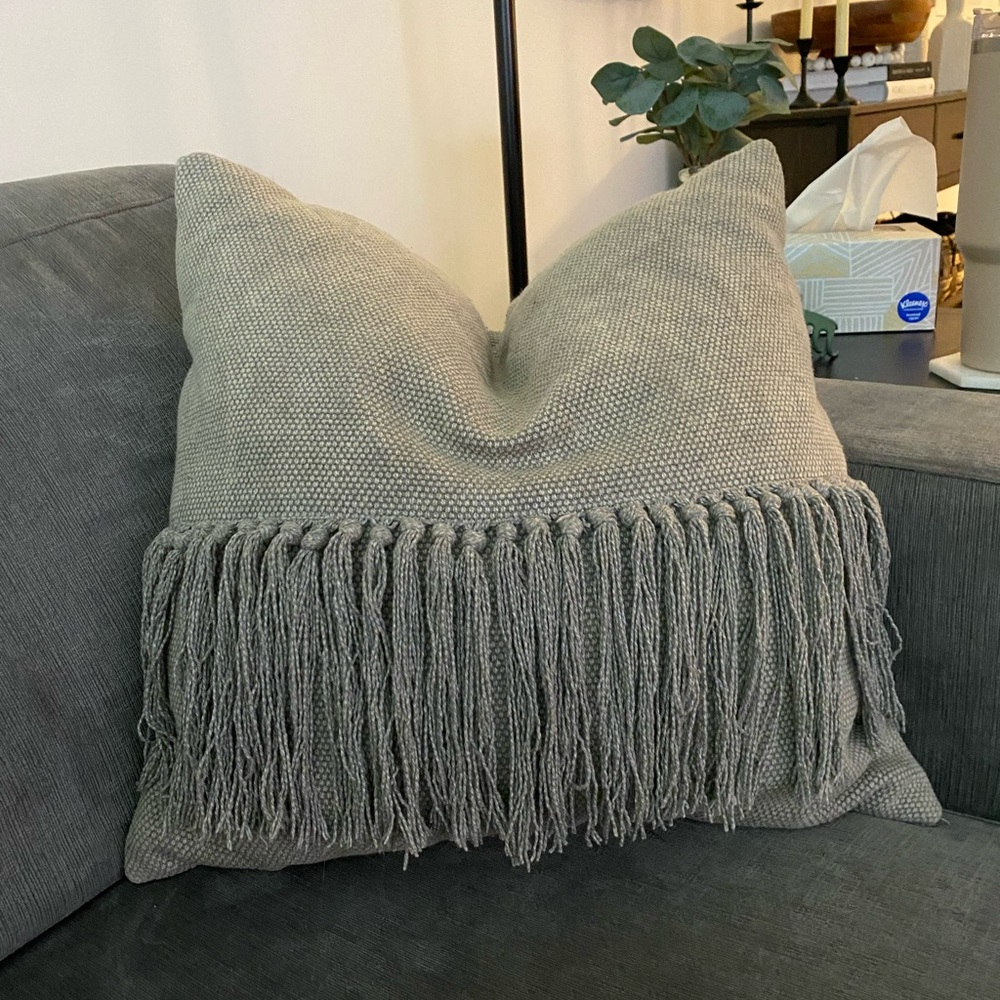 Grey textured pillow with fringe